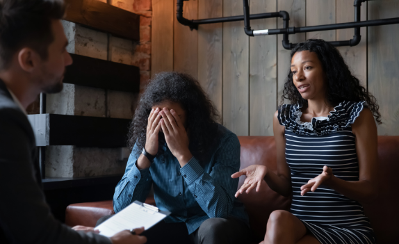 two people sitting on a couch talking to a therapist in Drug Treatment for Couples and Couples Substance Abuse Counseling