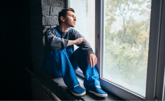 Man Sitting at Window Telehealth substance abuse counseling